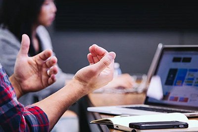 Man using hsi hands to explain things at a community meeting